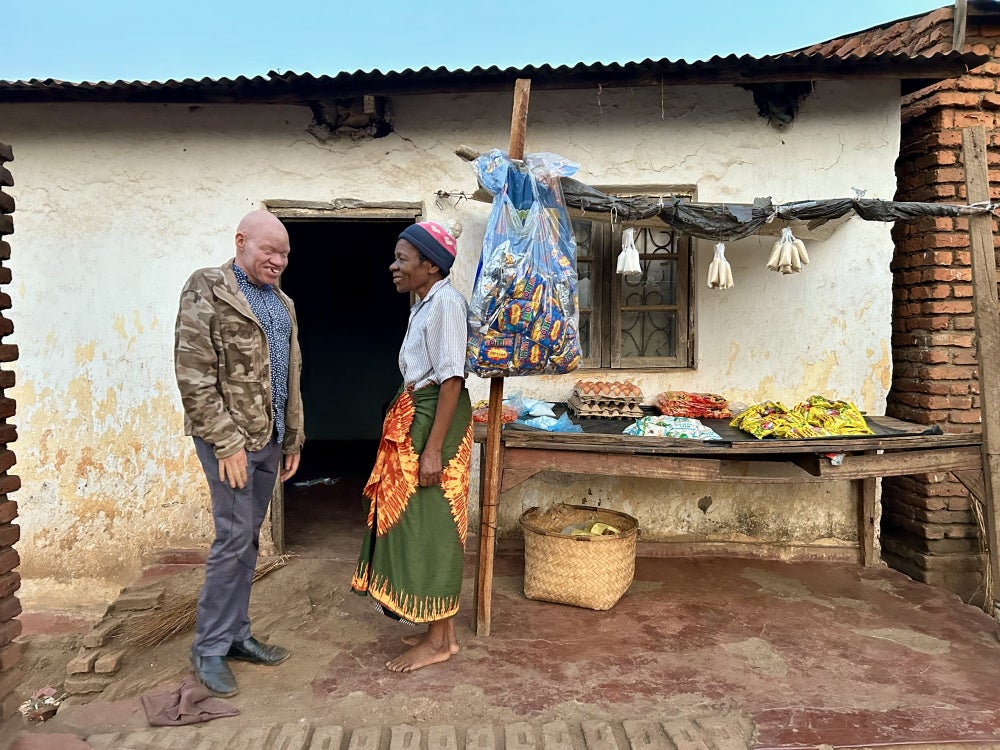 Adson B. and his mother, Kerina, outside their home in Dowa, Malawi. 