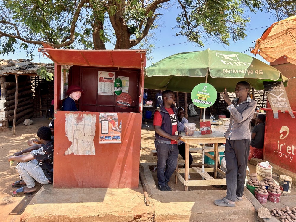 Maureen Kamatu, 28, has been self-employed at a mobile money cash-transfer booth in Lilongwe, Malawi. 