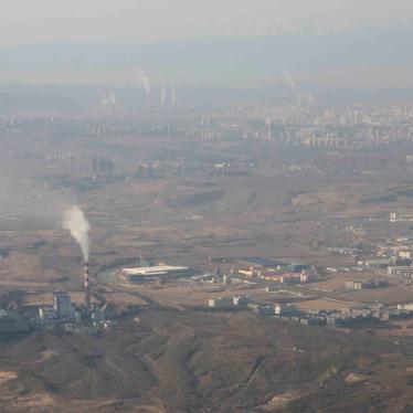 Smoke and steam rise from towers