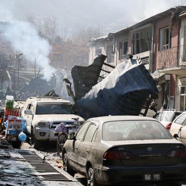 Afghan security officials inspect the site of a Taliban suicide bombing in Kabul.