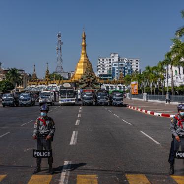 Police block a road leading to City Hall as protesters approach on February 13, 2021, in Yangon, Myanmar. 
