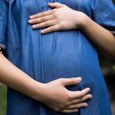 Pregnant woman holding her belly. 