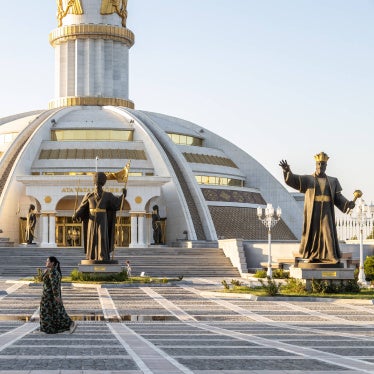 People walk in front of Independence Monument in central Ashgabat, Turkmenistan on August 9, 2025.