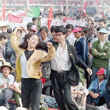 University students dance during the pro-democracy demonstration in Tiananmen Square on May 22, 1989, in Beijing, China. 