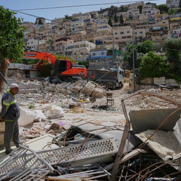 A Palestinian man looks on as an excavator clears the rubble of homes demolished by Israeli authorities in the Silwan neighborhood of east Jerusalem, May 19, 2026.