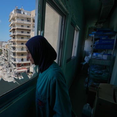 A nurse looks out of the Jabal Amel Hospital at areas struck during an Israeli airstrike in the southern port city of Tyre, Lebanon, June 2, 2026.
