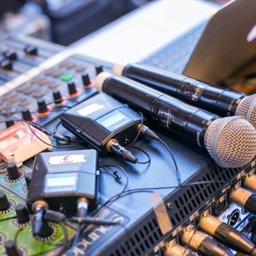 Microphones and receivers on a mixing desk. 