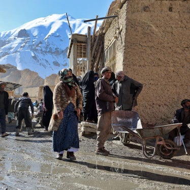 People congregate outside a World Food Programme food distribution center in Yakawlang, Bamyan province, Afghanistan, January 1, 2026. 