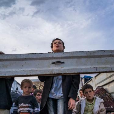 SEPTEMBER 2014. Syrian Kurdish refugees look out from the back of a truck as they enter Turkey from the town of Kobane (Ayn al-Arab), Syria, and surrounding villages. © 2014 Michael Christopher Brown/Magnum
