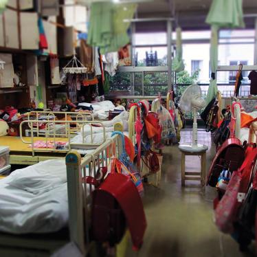 Beds in sleeping quarters for elementary school girls at a child care institution in Iwate prefecture. Eight girls share a room, and the space on their own bed is the only place children are allowed some privacy. 