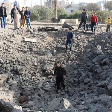 A child stands in the hole created by the impact of what local activists say was a ballistic missile. 