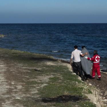Member of Greek Red Cross helps an Afghan refugee who has just arrived from Turkey with an inflatable boat in the area of airport of Mytilene, Lesvos Island, Greece.