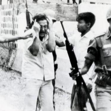 A student is led away after a raid on a university in Jakarta, Indonesia in 1965.