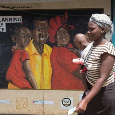 A woman walks past a mural on a Family Health Options clinic in the Kibera slums in Nairobi, Kenya, May 16, 2017. © 2017 Reuters