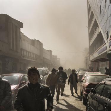 People flee after an ambulance rigged with explosives detonated in central Kabul, killing 103, January 27, 2018.