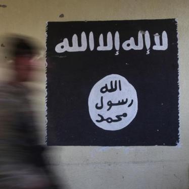 A member of the Iraqi security forces walks past a wall painted with the black flag commonly used by ISIS in Mosul, Iraq, January 8, 2017. © 2017 Reuters