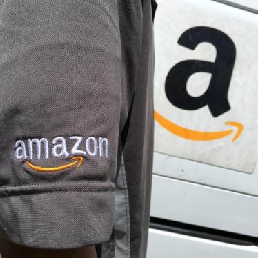 An Amazon.com Inc driver stands next to an Amazon delivery truck in Los Angeles, California, U.S., May 21, 2016.