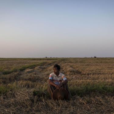 La Win, 61, a farmer from the Ayeyarwady Region, sits on a portion of the 35 acres of land he said was taken from him in 2004 by a company. 