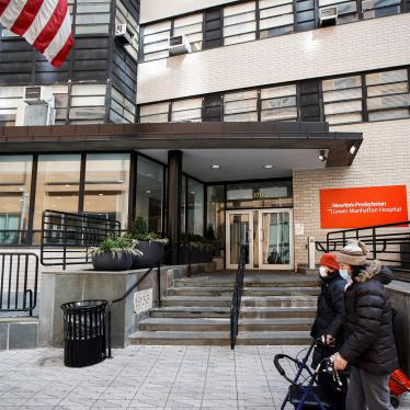 Pedestrians wearing masks walk by New York Presbyterian Lower Manhattan Hospital in New York, Monday, March 16, 2020.