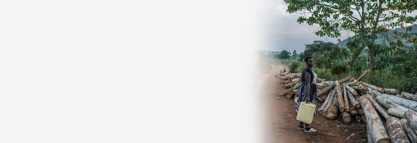 A woman walks home from work in Kijumba, Uganda, January 14, 2023
